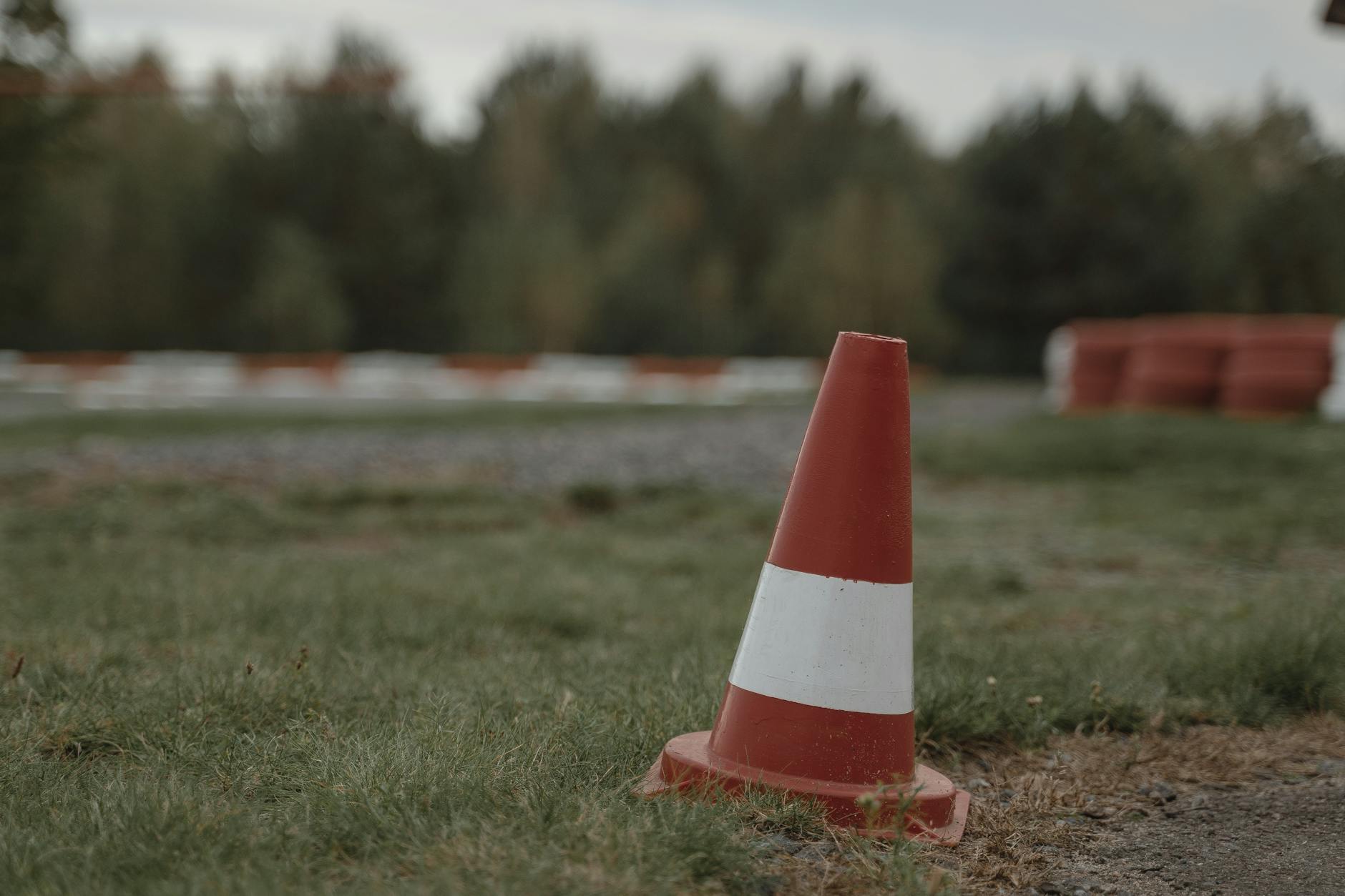 orange and white traffic cone on green grass field